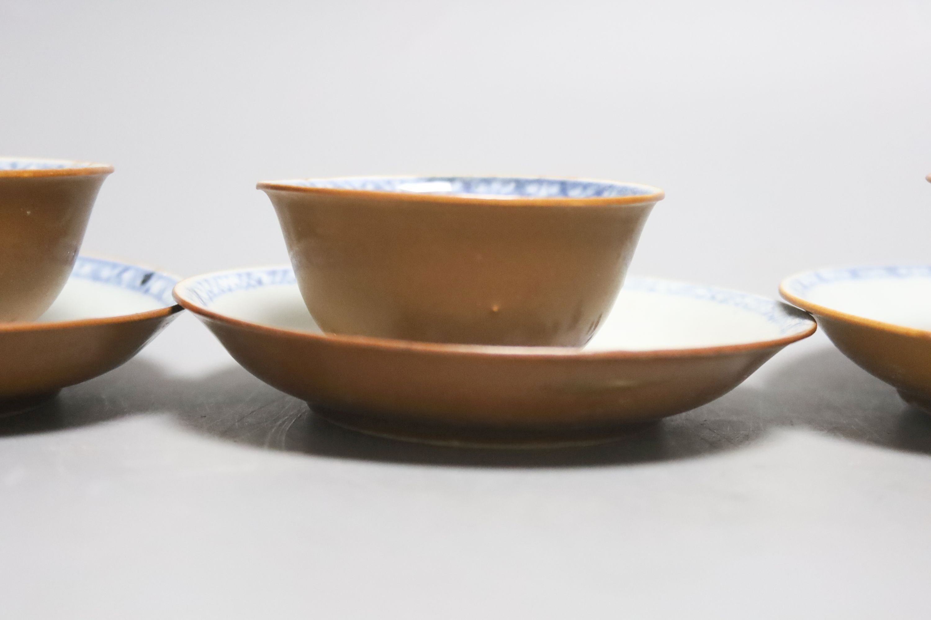 A set of four Chinese Nanking Cargo blue and white teabowls and saucers, with cafe au lait ground